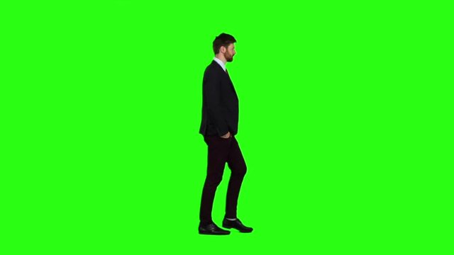 Businessman is going to a meeting and waving greetings. Green screen. Slow motion