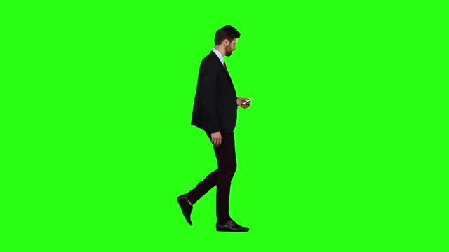 Guy looks at the photo on the phone and finds a list of pictures. Green screen. Slow motion