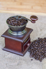 Coffee grinder full of roasted coffee beans and coffee beads on the right side - from the top