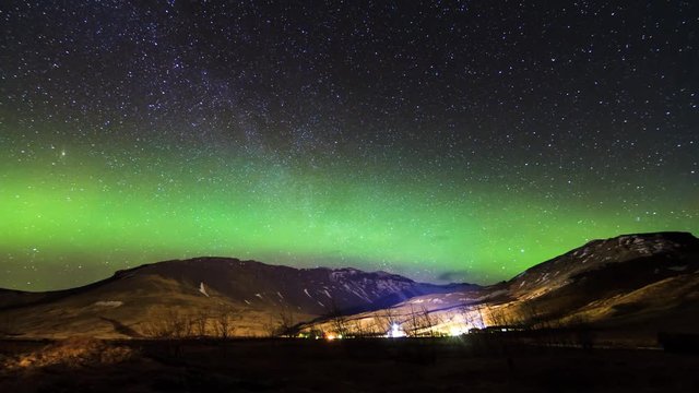 Beautiful full HD time-lapse of a starry night in Iceland with a green and red glowing Aurora in the night sky