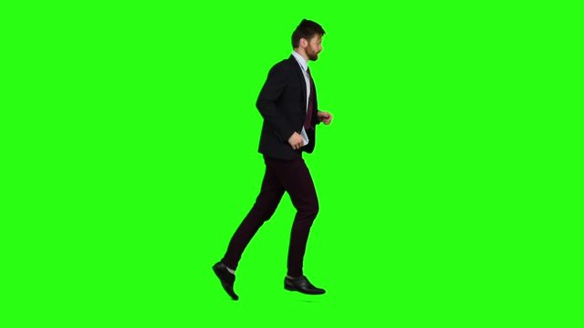 Businessman runs to work, is late for an important meeting. Green Screen. Slow motion
