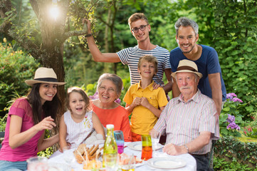 Family reunion around a picnic table in a beautiful garden