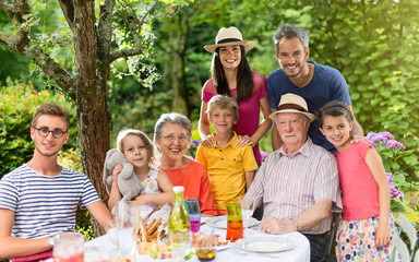 Family reunion around a picnic table in a beautiful garden