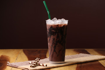 Ice cocoa soft drink on wood floor and topping