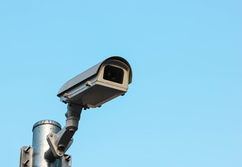 CCTV, Security Camera In The City On Blue Sky Background.