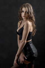 Fototapeta na wymiar beautiful woman in lingerie posing on black background
