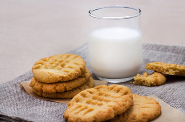 Healthy peanut butter cookies and glass of milk. Linen napkin background