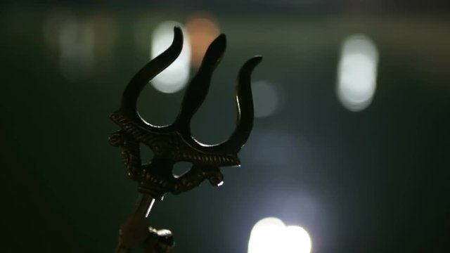 Trishul - a symbol of Hindu god Shiva. Trident is a Mahadeva symbol. Lord Shiva`s Trishul In the water of the sacred lake Shiva and his wife Pravati in Mahashivaratri puja.
