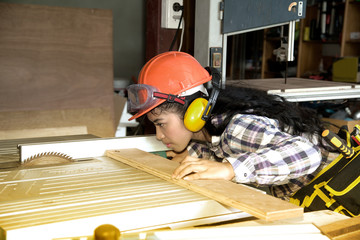 Asian pretty female carpenter Using Electric Sander for wood © topten22photo