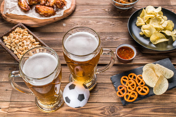 Appetizers and beer on the table for watch the football match.