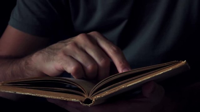 Man reading old book at home
