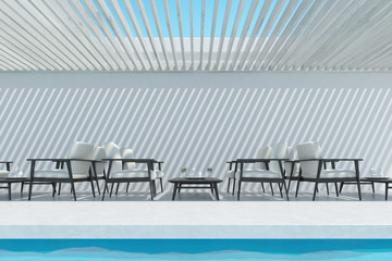 Swimming pool with white armchairs, table