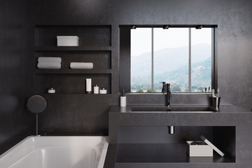Black bathroom, tub, sink and mirror close up