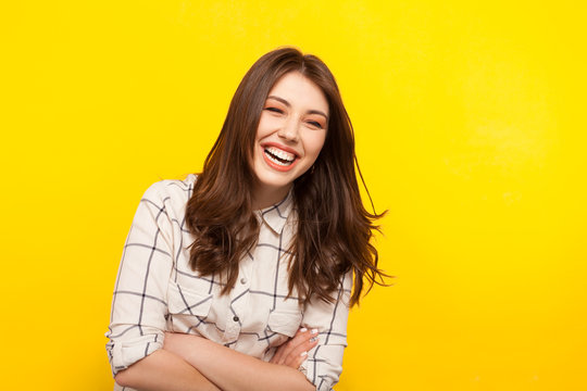 Laughing woman with hands crossed