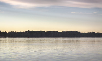 the trees in the water on the banks of the Volga river. the flood of the Volga river at dawn