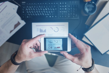 Man is taking shot of diagram using smartphone