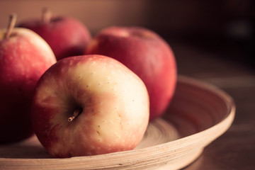 Apples in wooden tray.