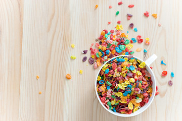 Kids healthy quick breakfast. Colorful rice cereal on wooden background. Copy space