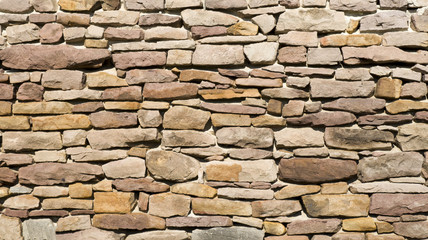 Old red stone wall closeup