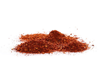 pile crushed red cayenne pepper, dried chili flakes and seeds isolated on white background