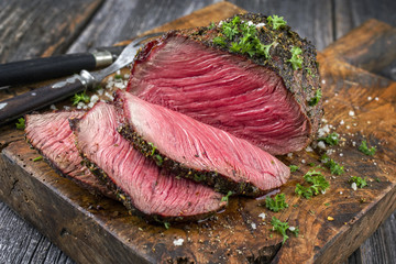Barbecue wagyu point steak sliced as close-up on a cutting board