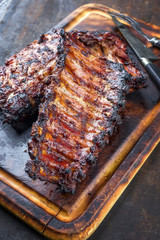 Barbecue Pork Spare Ribs as top view on a burnt cutting board