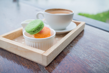 hot coffee breakfast set with fresh macaroon in outdoor bakery house cafe
