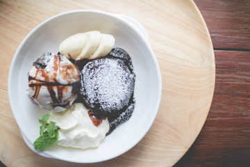 hot chocolate lava cake with vanilla ice cream ball, banana and whipped cream