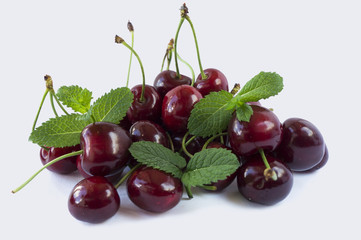 Sweet cherry berries isolated on white background cutout. Cherry fruit in a wooden bowl with copy space for text.