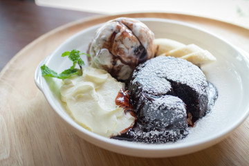 hot chocolate lava cake with vanilla ice cream ball, banana and whipped cream