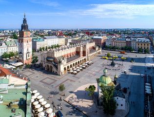 Main Market Square (Rynek), old cloth hall (Sukiennice), town hall tower, Church of St. Adalbert or St. Wojciech and renovated Mickiewicz statue in Krakow (Cracow) Poland. Aerial view