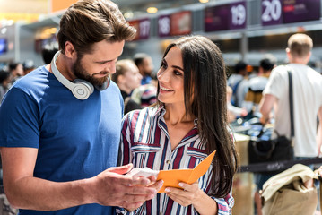 Cheerful couple holding planting documents