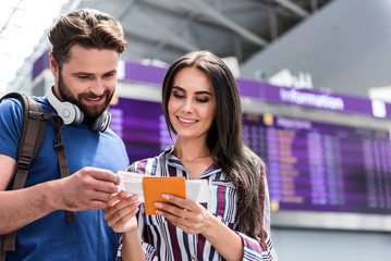 Cheerful man and woman waiting for their flight