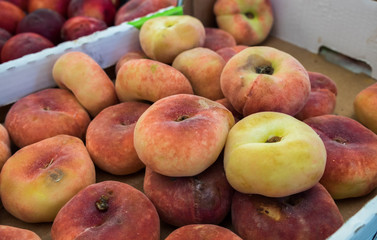 Saturn Peaches or Donut peaches sold at  local city market. Provence. France