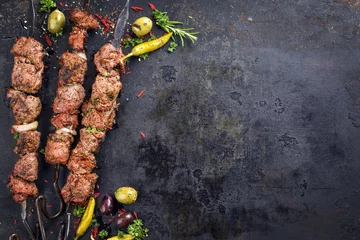 Wall murals Grill / Barbecue Traditional Russian shashlik on a barbecue skewer as top view with copy space on old rusty metal sheet