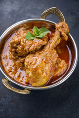 Traditional Indian Chicken Tikka Masala as close-up in a Korai