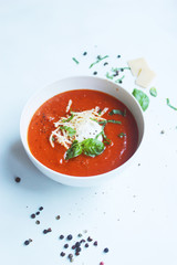 healthy creamy tomato soup with cheese and basil