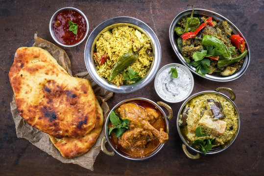 Traditional Indian Curries and Biryani with Mango Chutney and Pita Bread as top view