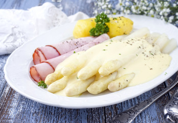 White Asparagus with Ham and boiled Potatoes as top-view on a plate