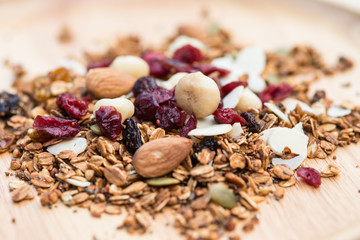 Closed up and blur breakfast healthy food, granola, musli, Organic oat, super food with honey, dried fruits and nuts on wooden plate