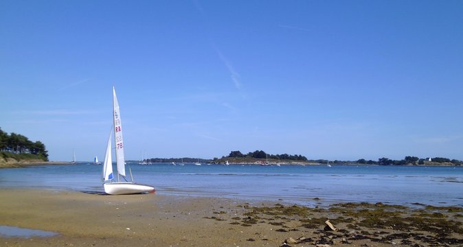 Sailboat stranded on a beach of Ile aux moines in Gulf of Morbihan, Brittany, France