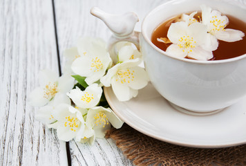Fototapeta na wymiar Cup of tea with jasmine flowers
