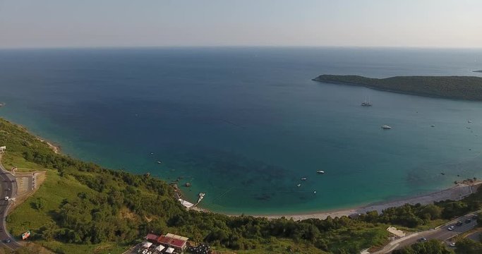 Aerial view of the seashore landscape of Budva with mountain road, Montenegro. Mountain, forest, sandy baech and an Adriatic sea bay
