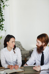 Two contemporary bankers discussing sales and data