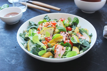 healthy salmon salad with pears tomatoes and sesame seeds