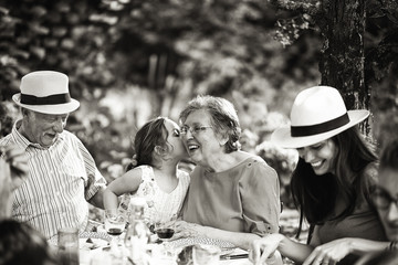 Three generations family having lunch in the garden