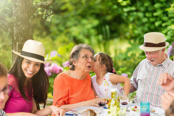 Three generations family having lunch in the garden