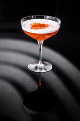 A glass of cocktail on black background