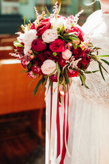 Wedding image and a bridal bouquet with red flowers