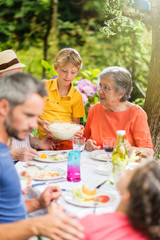 Three generations family having lunch in the garden